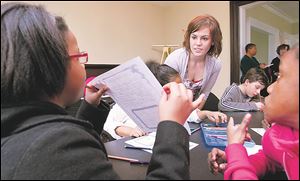 Paris Harton shows United Way's Kirsta Nagy her story during a workshop to learn how to write stories.