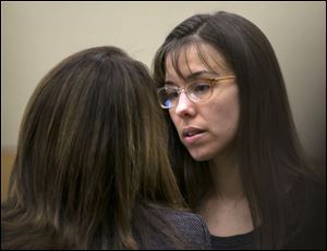 FILE - In a Thursday, April 11, 2013 file photo, Jodi Arias, right, talks to her attorney, Jennifer Wilmott, during her murder trial in Phoenix. Dozens of enthusiasts flock to court each day for a chance to score one of a handful of seats open to the public in Arias’ ongoing murder case in Arizona. The tickets are given out on a first-come, first-served basis, and nearly four months into the trial, the crowds are growing.  This week, one trial regular sold her spot to another person for $200 _ and both got reprimands from the court on Tuesday, April 23, 2013. (AP Photo/The Arizona Republic, David Wallace, Pool)