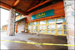 Yellow caution tape keeps customers away from the entrance to the Dundee, Mich., Cabela’s store, and a notice on the firm’s Web site serves notice that the retailer was closed because of fire.