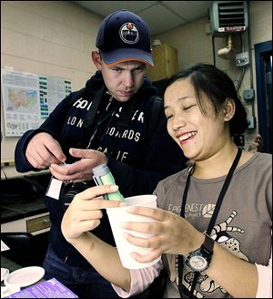 Wayne Woods of Canada and Barkha Subba of India test water samples at the Toledo Zoo’s annual Amphibian Academy. Researchers are quite concerned about a  fungus that harms amphibians.