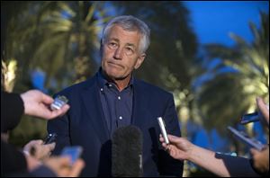 U.S. Secretary of Defense Chuck Hagel speaks with reporters after reading a statement on chemical weapon use in Syria during a press conference in Abu Dhabi, United Arab Emirates.