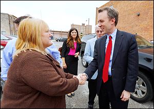 Pam Weirauch, owner of Pam’s Corner, greets Democratic gubernatorial candidate Ed FitzGerald at her restaurant in down-town Toledo, where he met with about 40 supporters Thursday.