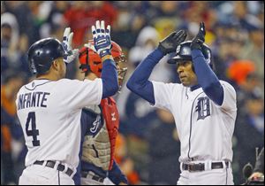 Detroit’s Austin Jackson, right, is congratulated by Omar Infante after hitting a three-run home run in the third inning. Infante also homered as the Tigers swept the series against Atlanta.