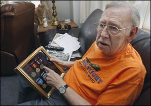 Korean War vet Bill Williams, with medals he received for wartime service, also recalls growing up during World War II, when he lived near the POW camp at the Rossford Ordnance Depot.  