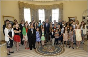 Former President George W. Bush, center, poses with 43 students from Dallas-Fort Worth Schools who were the first 43 official guest to tour the Bush Presidential Library on its' opening day in Dallas.