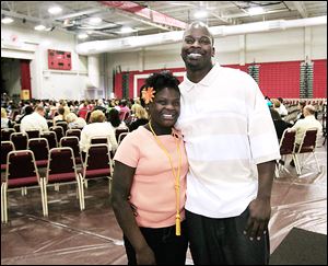 Alasha Higgs and her dad, Brad Higgs, share a moment before the start of commencement on Friday at Owens Community College's Perrysburg Township campus. Her father was selected to address fellow graduates during the school’s 47th annual commencement ceremony. 