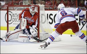 Washington Capitals goalie Braden Holtby makes a save against New York Rangers right wing Darroll Powe during the second period.