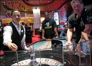 A dealer at Revel prepares for another round of roulette at the Atlantic City, N.J., casino as patrons await the result. 