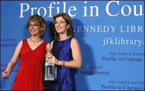 Caroline Kennedy, right, poses with former Arizona Congressman Gabrielle Giffords after presenting her with the John F. Kennedy Profile in Courage Award at the JFK Library in Boston on Sunday.