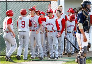 Andy Okuley, left, and Max Lyon (9) are greeted by St. Francis teammates after scoring against St. John's.