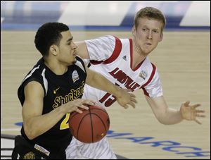 Wichita State's Fred Van Vleet (23) moves the ball as Louisville's Tim Henderson (15) defends during a the NCAA Final Four tournament semifinal game, April 6 in Atlanta. Louisville went on to defeat Michigan in the championship game.