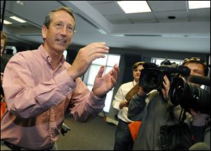 Former South Carolina Gov. Mark Sanford gestures after voting at a polling place today in Charleston, S.C.