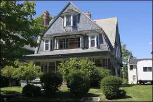 The 'Blue House' at 1019 North Summit St. is adjacent to Aurora House in Toledo's Vistula Historic District, a neighborhood in the National Register of Historic Places.