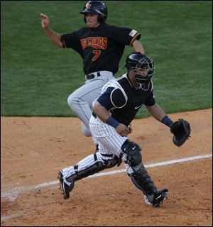 Rochester's Doug Bernier gets by Toledo catcher Ramon Cabrera to score on a double by former Mud Hen Clete Thomas.