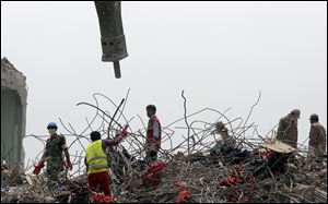 Rescuers work at the site of the eight-story Rana Plaza building that collapsed in Savar, near Dhaka.