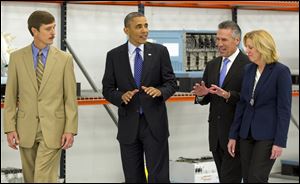 President Barack Obama tours Applied Materials Inc., with Rick Gesing, left, Mike Splinter, center, and Mary Humiston, right, during a visit to the facilities in Austin, Texas.