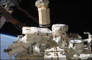 Astronauts Tom Marshburn, left, and Christopher Cassidy participate in a spacewalk for maintenance tasks.