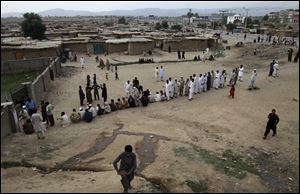 Pakistani voters line up outside a polling station waiting to enter and cast their ballots today on the outskirts of Islamabad, Pakistan.