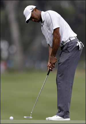 Tiger Woods putts on the sixth green for par during the third round of The Players championship golf tournament at TPC Sawgrass today in Ponte Vedra Beach, Fla. 