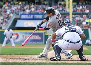 Cleveland's Jason Kipnis smacks a two-run double off Tigers starting pitcher Rick Porcello during the third inning. The double tied the game, but the Indians were later forced to rally in the ninth.