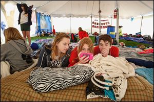 Rachel Phalen, 13, center left, Alexa Borgerson, 13, center, and Luke Kilcorse, 13, take a break and catch up on their television in the District 5 team tent. The 13 teams totaling 130 participants were joined by about 50 volunteers to spend 24 hours together to promote a drug and alcohol-free life. 