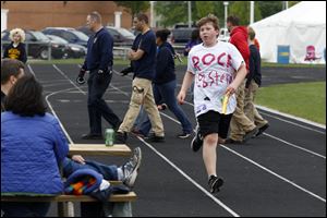 Bradley Wilichowski, 13, of the Rock Lobster team passes the  lap-counting table during the 20th Annual Sylvania 24-Hour Relay Challenge on Saturday.