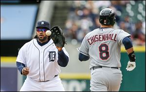 The Tigers' Prince Fielder, left, catches a throw from pitcher Rick Porcello to get the Indians' Lonnie Chisenhall out in the fourth inning of Sunday's 4-3 Cleveland win at Comerica Park.