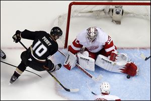 Ducks right wing Corey Perry, left, tries to get a shot in on Red Wings goalie Jimmy Howard during the second period in Game 7 of their first-round series Sunday in Anaheim, Calif. Howard made 31 saves as the seventh-seeded Red Wings ousted the Ducks, who had the NHL's third-best record in the regular season.