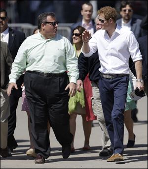 Britain's Prince Harry, right, walks with New Jersey Gov. Chris Christie at Casino Pier during a tour of the area hit by Superstorm Sandy, today, in Seaside Heights, N.J.