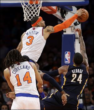 New York Knicks' Kenyon Martin (3) blocks a shot by Indiana Pacers' Paul George (24) in the second half.