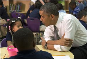 President Barack Obama greets a pre-kindergarten class of children at Moravia Park Elementary School in Baltimore during his second 