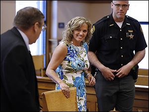 Terri Camp Kruse leaves Ottawa County Common Pleas Court on Friday with her attorney, William Hayes, left, after being granted limited driving privileges by Judge Bruce Winters.