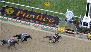 Oxbow (6), ridden by jockey Gary Stevens, wins the 138th Preakness Stakes horse race ahead of Itsmyluckyday (9), ridden by John Velazquez, and Mylute, ridden by Rosie Napravnik at Pimlico Race Course today in Baltimore.