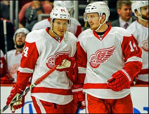 The Red Wings' Gustav Nyquist, right, smiles as he talks with Damien Brunner during Game 2 against Chicago. The duo are a major part of Detroit’s youth movement this season.