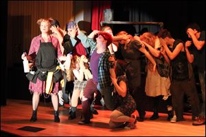 The cast of 3B Productions' presentation of 'Urinetown the Musical' rehearses for shows today through Sunday at the Maumee Indoor Theater.