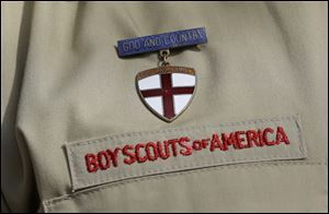 A close up detail of a Boy Scout uniform worn by Brad Hankins, a campaign director for Scouts for Equality, as he responds questions during a news conference in front of the Boy Scouts of America headquarters in Irving, Texas.