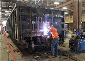 John Spurlock welds on a  railcar at The Andersons’ railcar-repair facility in Maumee. The Ander­sons’ rev­e­nues rose sig­nifi­cantly in 2012 to $5.3 bil­lion from $4.6 bil­lion in 2011. Fueling that rise was the growth in its grain, ethanol, and plant-nutrient divisions. 