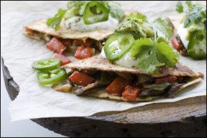 Mushroom, pepper and onion quesadillas are shown in Concord, N.H. Full-fat cheese is the secret to a flavorful recipe.