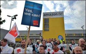 Employees of online retailer Amazon are on protest in front of the company's branch in Leipzig, Germany, Tuesday, May 14.