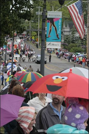 Elmo and scores of other umbrellas line the route of the parade along South Main Street.