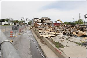 The demolition underway of the old Colony shopping center at the corner of Monroe Street and Central Avenue.