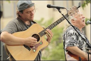 John Barile playing slide, left, and Bobby May, right, singing.    