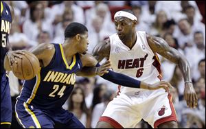 Miami Heat forward LeBron James (6) defends Indiana Pacers forward Paul George (24) during the second half.