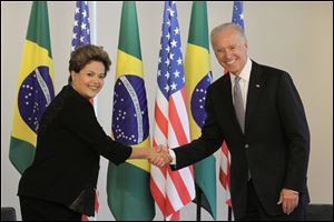 U.S. Vice President Joe Biden, right, shakes hands with Brazil’s President Dilma Rousseff.