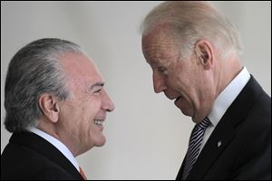 U.S. Vice President Joe Biden, right, talks with Brazil’s Vice President Michel Temer.