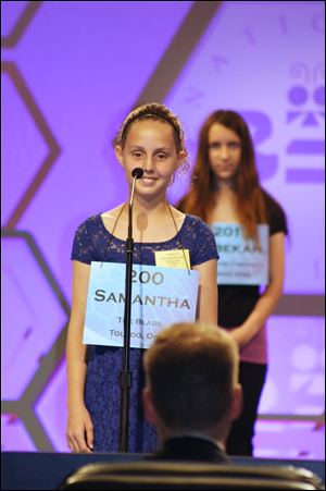 Samantha Schofield stands on stage as she spells the word ‘amphibious’ in the National Spelling Bee on Wednesday.