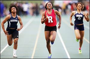 Sasha Dailey, center, of Rogers wins the 200-meter dash at the Division I regional track meet in Amherst, Ohio.