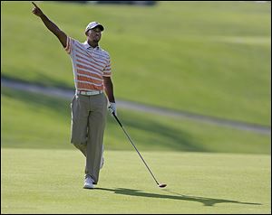 It was a tough day for Tiger Woods, signaling as he follows his second shot on the 11th hole during the second round of the Memorial.