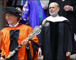 Princeton University's Dr. Jeff Nunokawa, Professor of English, holds the the school's ceremonial mace as Ben S. Bernanke, Chairman of the Federal Reserve, leads the processional out of Princeton University Chapel after giving the Baccalaureate address during an interfaith service Sunday in Princeton, N.J.