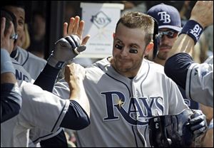 Tampa Bay Rays' Evan Longoria is greeted in the dugout after a two-run home run off Cleveland Indians relief pitcher Matt Langwell in the eighth inning.